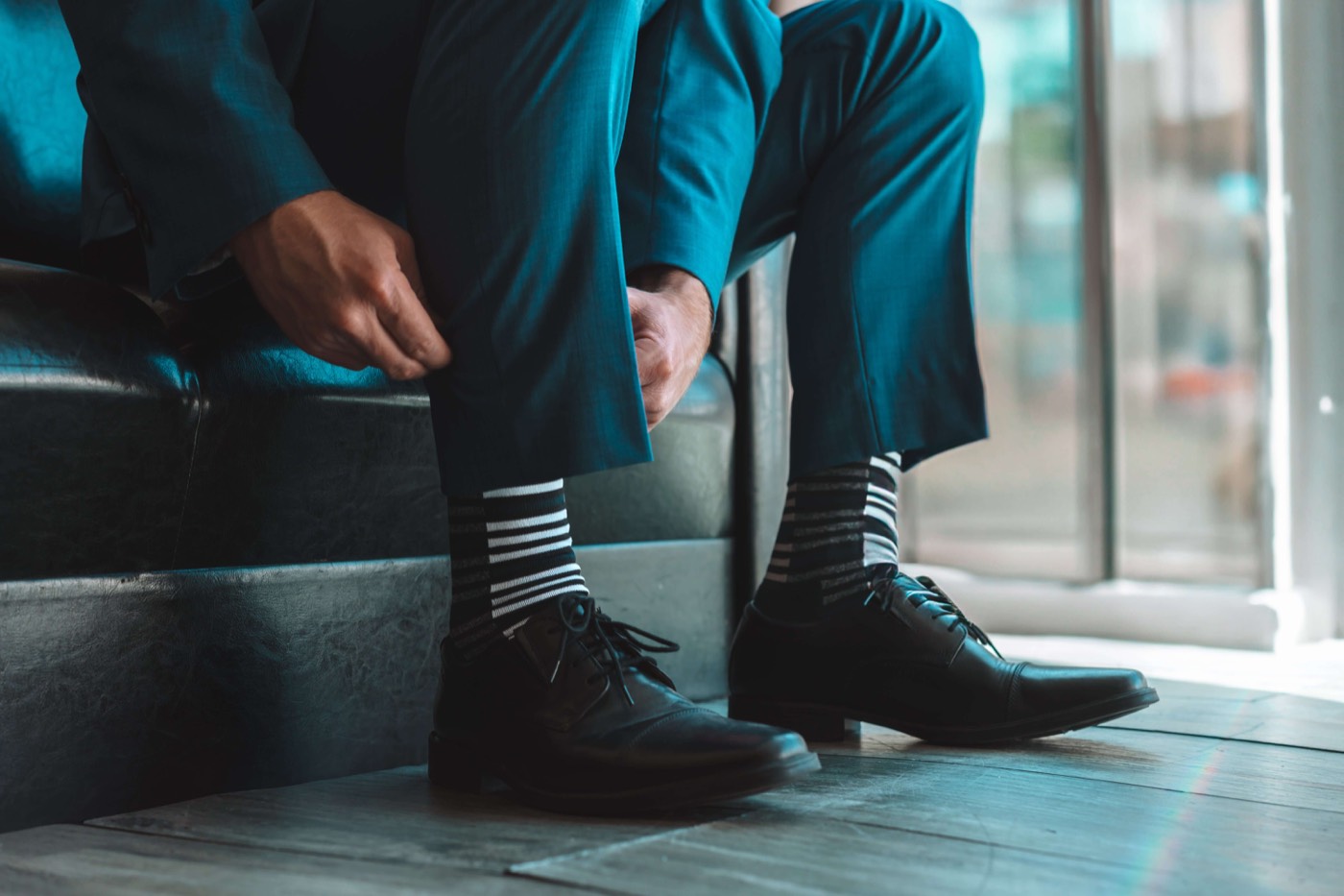 Striped Remo Tulliani dress socks worn with black oxfords and a teal suit